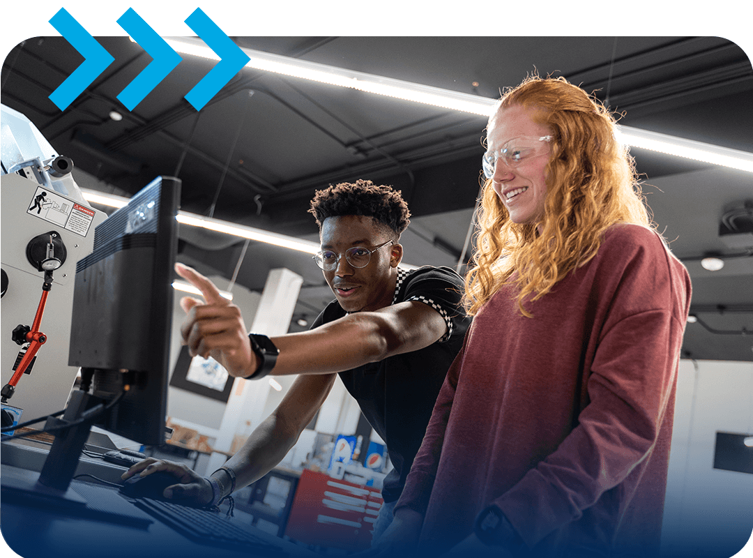 Students working on a computer in an engineering lab.