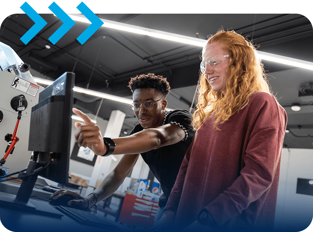 Students working on a computer in an engineering lab.