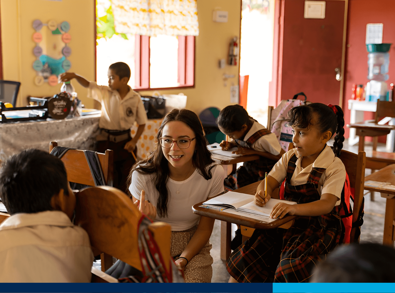 A student teaching children in a school