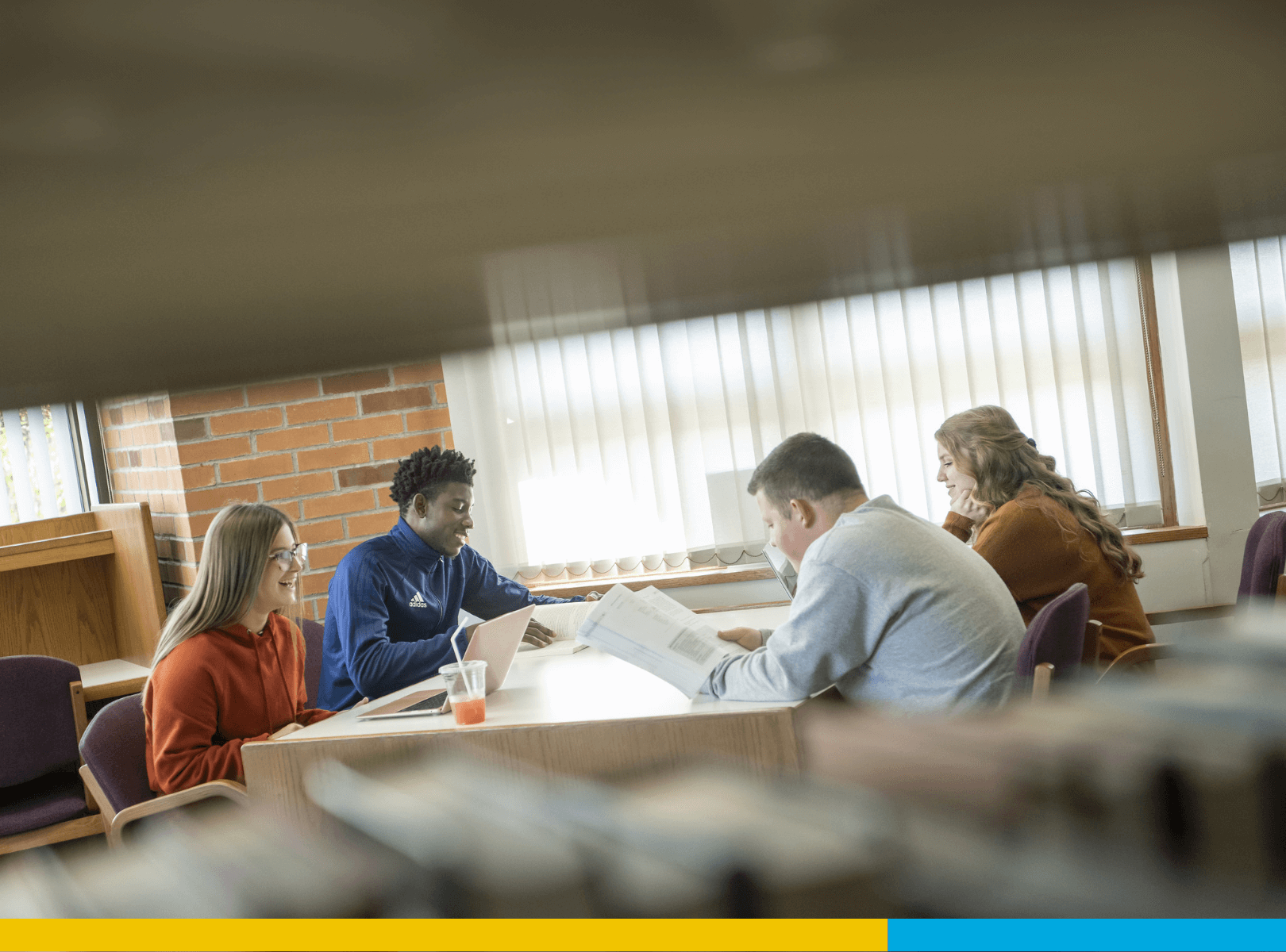 Four students sitting at a table, deep in conversation