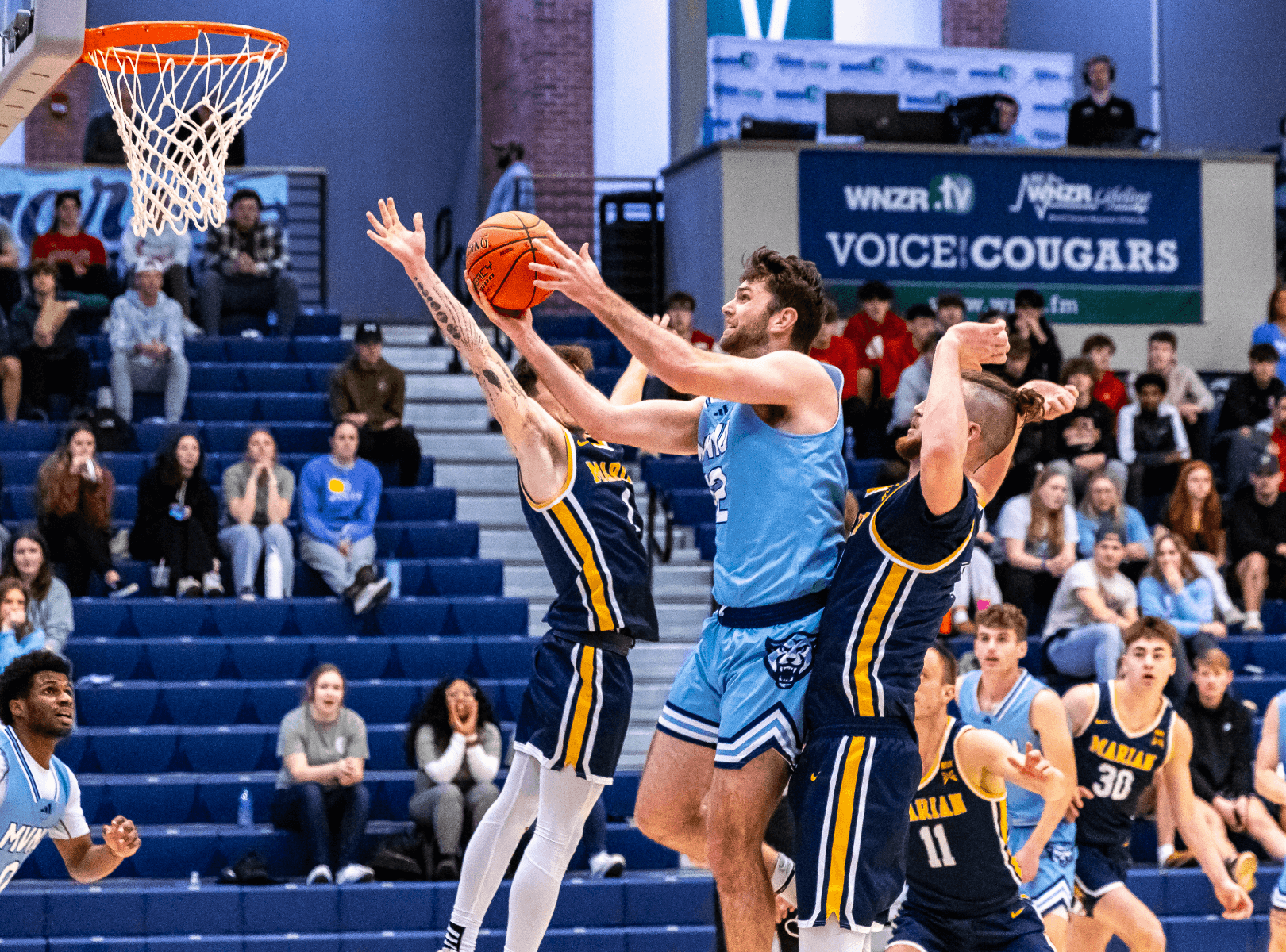 An MVNU basketball player taking a shot during an exciting game