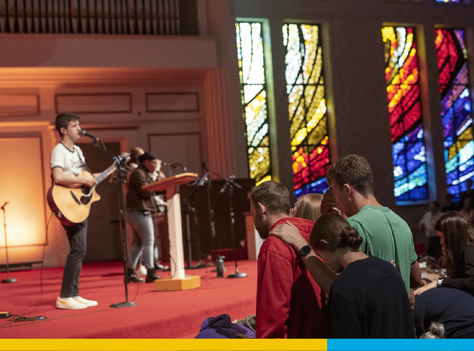 Students listening to a worship band.