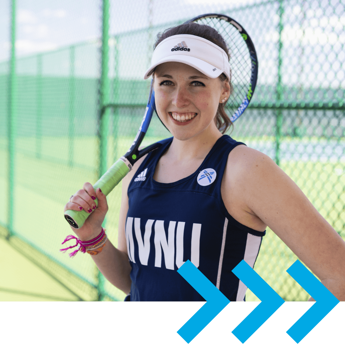 A smiling MVNU student posing with her tennis gear