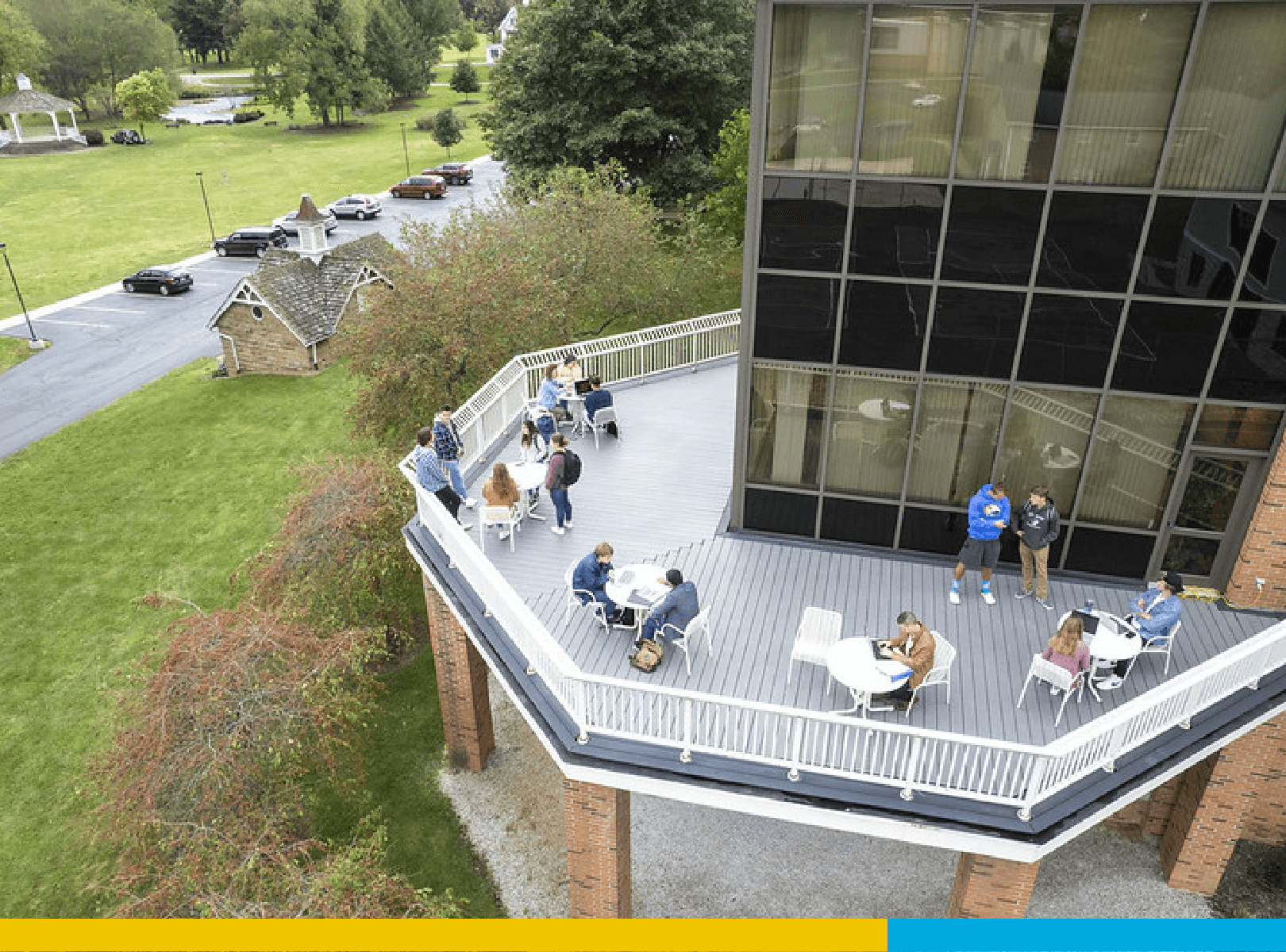 An aerial view of a campus deck with students on it