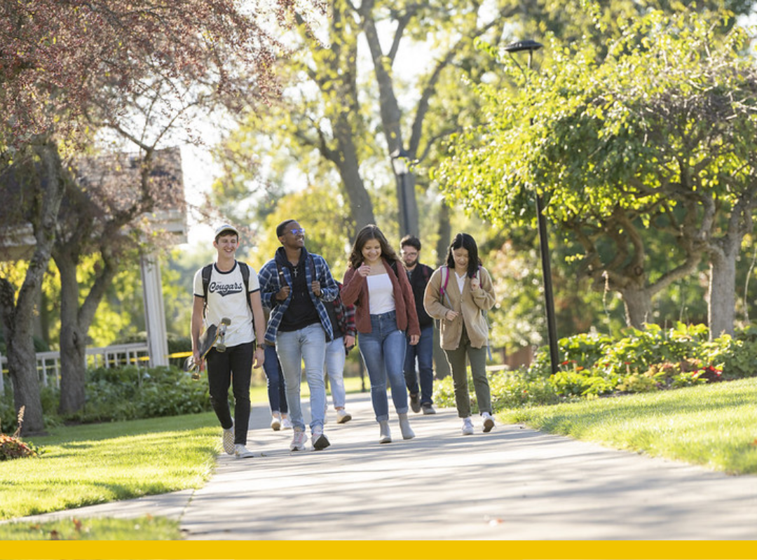 A diverse group of students walking together on campus